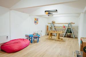 a room with a red bean bag chair and a table at Beautiful Cottage in Bredfield near to Woodbridge on the Suffolk Coast in Bredfield
