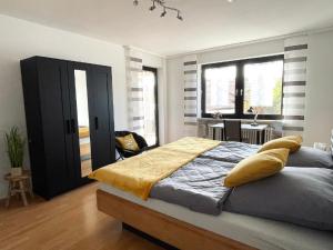 um quarto com uma cama grande e um cobertor amarelo em Ferienwohnung Hoamatgfühl em Furth im Wald