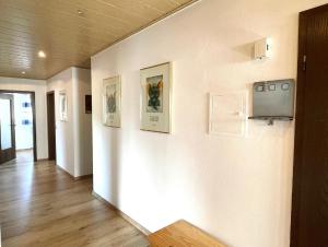 a hallway with a tv and pictures on the wall at Ferienwohnung Hoamatgfühl in Furth im Wald