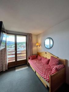um quarto com uma cama e uma grande janela em RISOUL - Résidence ALTAIR - 5 couchages - À 1min à pieds des pistes em Risoul