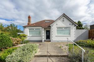 a white house with a pathway leading to it at Craigey Beach Home in Edinburgh