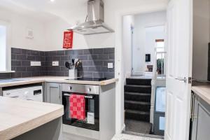 a kitchen with a sink and a stove top oven at 1 bed central Newport Apartment, sleeps 3 in Newport