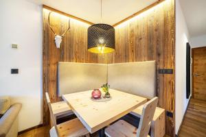 ein Esszimmer mit einem Holztisch und Stühlen in der Unterkunft Ferienwohnung Kuppelwies 363 in Ulten