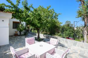 Biały stół i krzesła na patio w obiekcie Villa Suzana w mieście Mikrós Prínos