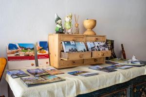 una mesa con revistas y libros encima en Mösslhof App Garten en San Vito