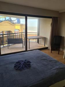 a bedroom with a bed and a view of a balcony at luxurious apartment with sea view in Blankenberge
