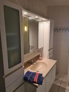 a bathroom with a sink and a mirror at luxurious apartment with sea view in Blankenberge