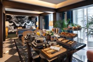 a buffet of food on a table in a room at The Chess Hotel in Paris