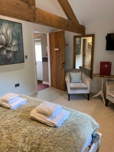 1 dormitorio con 1 cama con 2 toallas en The Brosterfield Suite - Brosterfield Farm, en Bakewell
