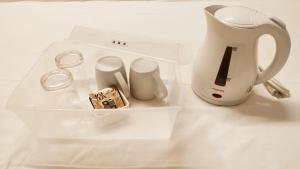 a white tea kettle and other items on a table at Mutsumi Building - Vacation STAY 00543v in Tokyo
