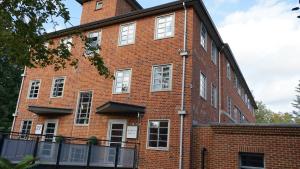 a large red brick building with white windows at Easthampstead Park in Bracknell