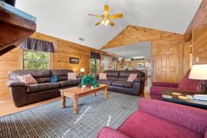 Una sala de estar con sofás y una mesa. en Poplar Point Condo Unit 12D, en Pigeon Forge