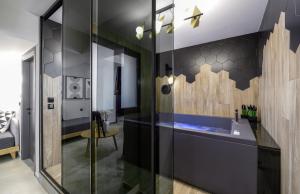 a bathroom with a sink and a glass wall at Pillow urban stay in Thessaloniki