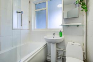 a white bathroom with a sink and a toilet at Statera Apartments - Studio Apartment in Walworth in London