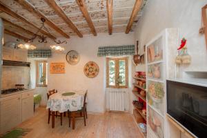 a kitchen with a table and a dining room at Red Elegant and Charming Country House near Rome in Rocca di Papa
