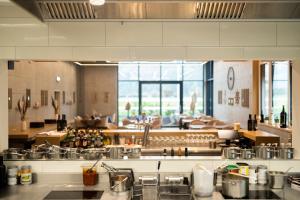 a large kitchen with many pots and pans at City Hotel Glarnerland in Näfels