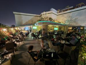 a group of people sitting at a restaurant at night at Carlton Downtown Cairo in Cairo
