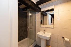 a bathroom with a sink and a shower at Pavilion Orpington in Foots Cray