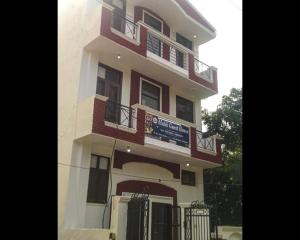 a building with a sign in front of it at Malik Guest House By WB Inn in Gurgaon