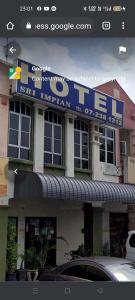 a building with a sign on the side of it at HOTEL SRI IMPIAN in Johor Bahru