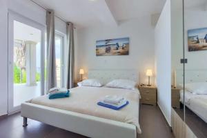 מיטה או מיטות בחדר ב-Zamy Villa