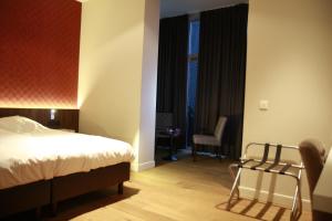 Ein Bett oder Betten in einem Zimmer der Unterkunft Hotel De Boskar Pelt