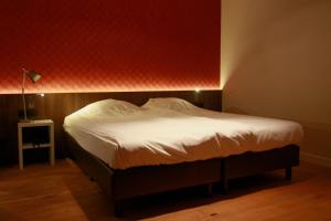 Ein Bett oder Betten in einem Zimmer der Unterkunft Hotel De Boskar Pelt