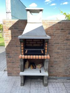 an outdoor oven sitting next to a brick wall at Refúgio da Légua in Marco de Canaveses