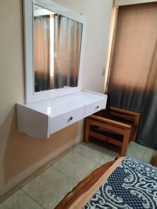 a white dresser in a bedroom with a mirror at Apartment in Luxor city center-Nil in Luxor