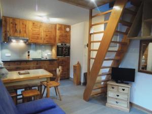 a kitchen with a spiral staircase in a room at Charmant Appartement avec Mezzanine et Balcon - 4-5 Pers., Garage, Proche Lac et Navette - FR-1-198-121 in Châtel +8 photos