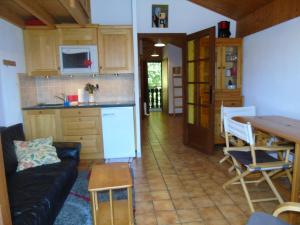 a kitchen and living room with a couch and a table at Appartement spacieux 6 personnes avec balcon à Châtel - FR-1-198-127 in Châtel