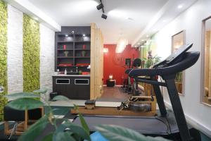 a room with a gym with a treadmill at Ambassadeur Hotel - Cherbourg Port de Plaisance in Cherbourg en Cotentin