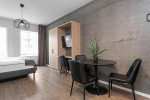 a bedroom with a table and chairs and a bed at Hotel Vera in Reykjavík