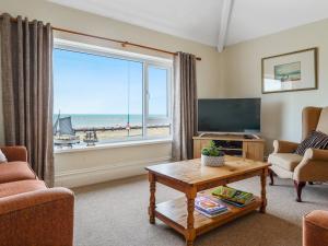 a living room with a view of the ocean at Pass the Keys Spacious 4 bed house overlooking Borth Beach in Borth