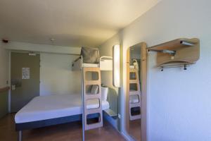 トロワにあるB&B HOTEL Troyes Centreの小さな客室で、ベッド1台、二段ベッドが備わります。