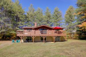 a large wooden house on a hill with trees at Franconia Cabin Retreat in Franconia