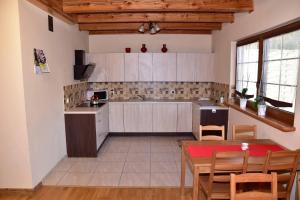 a kitchen with a table and a dining room at Nad Stawem in Powidz +16 photos