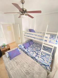 a bedroom with a bunk bed with purple pillows at S&H La Malquerida in Formentera del Segura