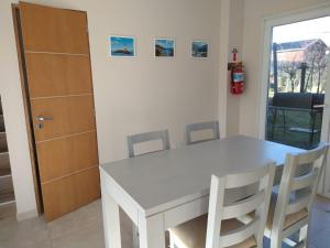 a white table and chairs in a room with a fire hydrant at Comarca Fueguina in Ushuaia