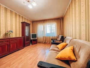 a living room with a couch and a tv at Apartments near the Exhibition Centre in Kyiv