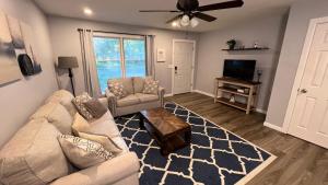 a living room with a couch and a tv at New Spacious Renovated Townhouse in Spring Hill