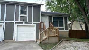 a house with a white garage door and a porch at New Spacious Renovated Townhouse in Spring Hill