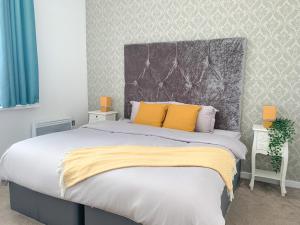 a bedroom with a large bed with yellow pillows at Duplex 2-bedroom apartment in Liverpool centre in Liverpool