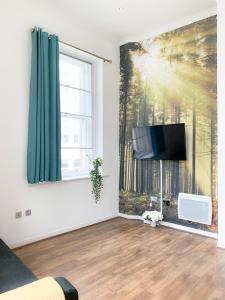 a living room with a tv and a window at Duplex 2-bedroom apartment in Liverpool centre in Liverpool