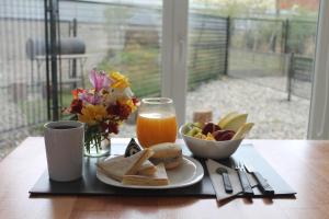 a table with a plate of food and a glass of orange juice at Monte Fueguino in Ushuaia