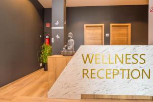 a sign that reads wellness reception in a room at Hotel Imperial in Tar