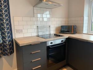 a kitchen with a stove and a counter top at The Lower Gathering - Sleeps Up To 13 in Sale