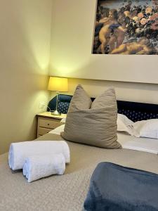 a bedroom with a bed with two pillows on it at Soggiorno Pezzati in Florence