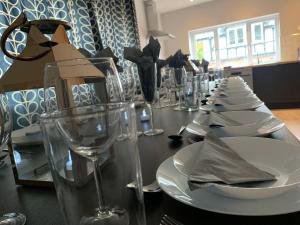 a long table with white plates and wine glasses at The Gathering Sale - Sleeps Up To 22 in Sale