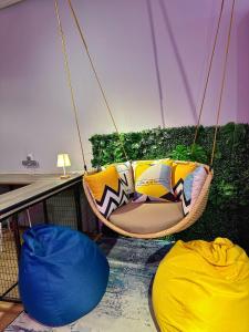 a hammock hanging from the ceiling of a room at Swing & Pillows @ Beach Street in George Town